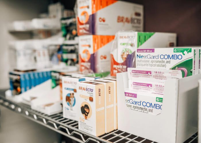 various boxes of pet medication sitting on a shelf